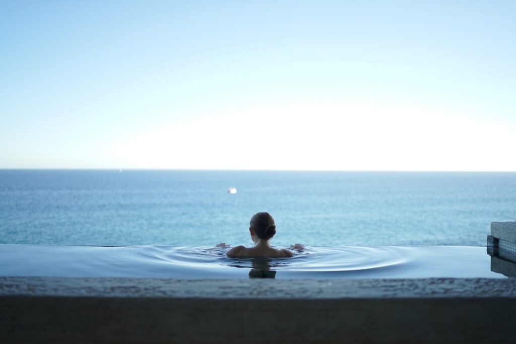 person in the ocean with bright blue sky